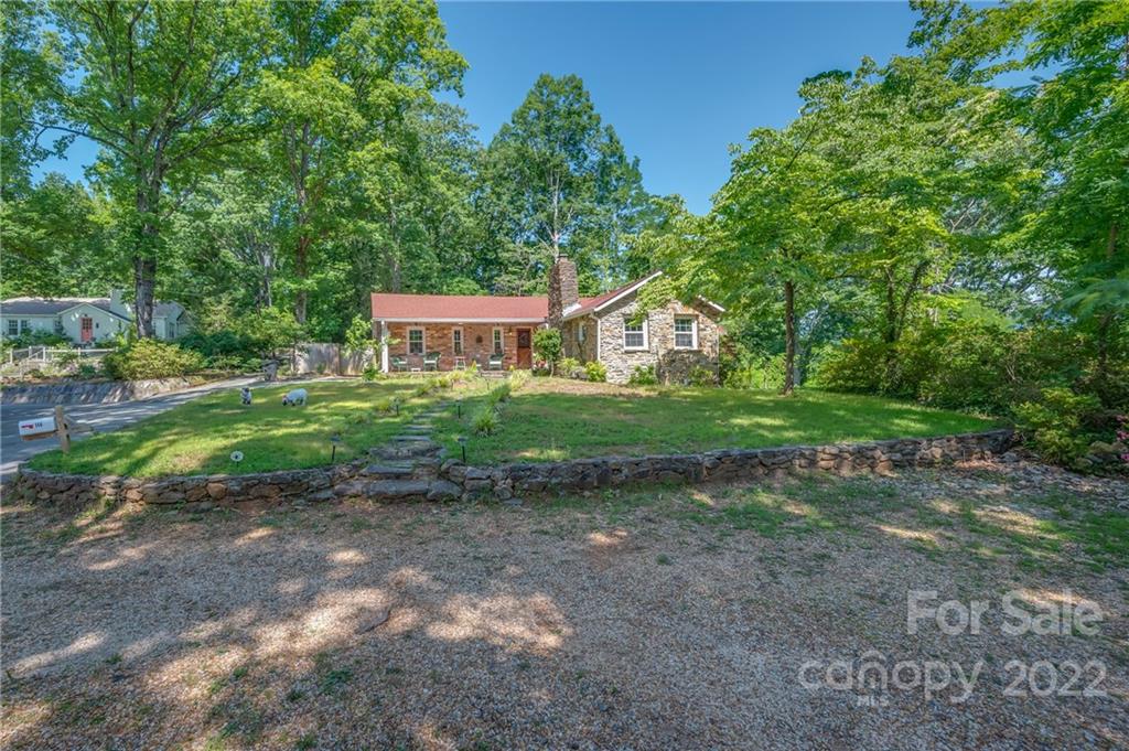 146 Hidden Hill Road Tryon, NC 28782 - Photo 40 of 43 a front view of a house with garden