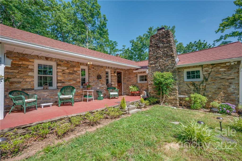 146 Hidden Hill Road Tryon, NC 28782 - Photo 43 of 43 a view of a chair and table in backyard of the house