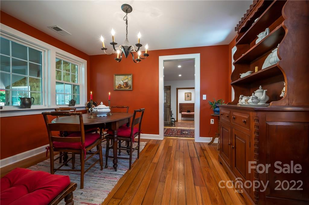 146 Hidden Hill Road Tryon, NC 28782 - Photo 5 of 43 a view of a dining room with furniture window and wooden floor