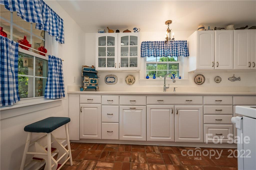 146 Hidden Hill Road Tryon, NC 28782 - Photo 6 of 43 a kitchen with cabinets appliances and a window