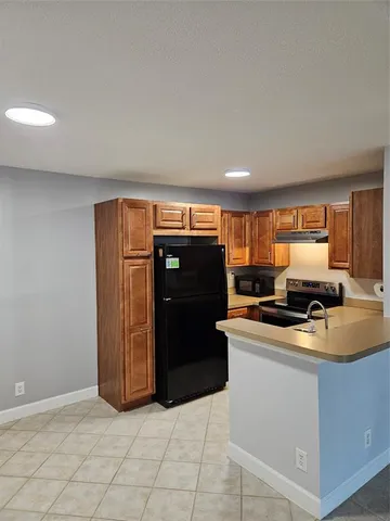 a kitchen with kitchen island a counter top space and appliances