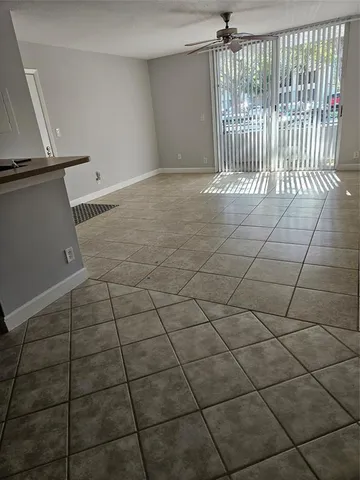a view of a room with a ceiling fan