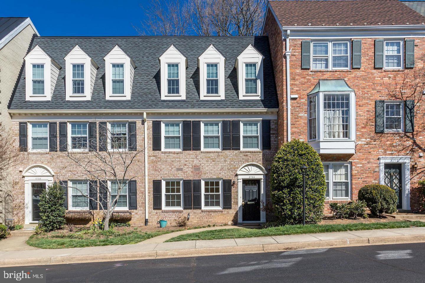 a front view of a building with a garden