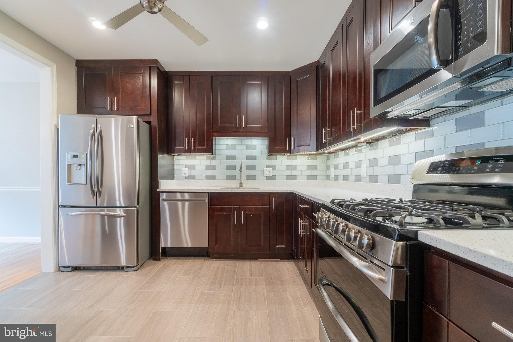 6754 Towne Lane Road McLean, VA 22101 - Photo 16 of 33 a kitchen with stainless steel appliances granite countertop a stove a refrigerator and a sink