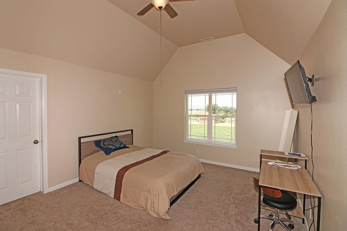 1198 23 Road Grand Junction, CO 81505 - Photo 17 of 32 a bedroom with a bed a window and chair