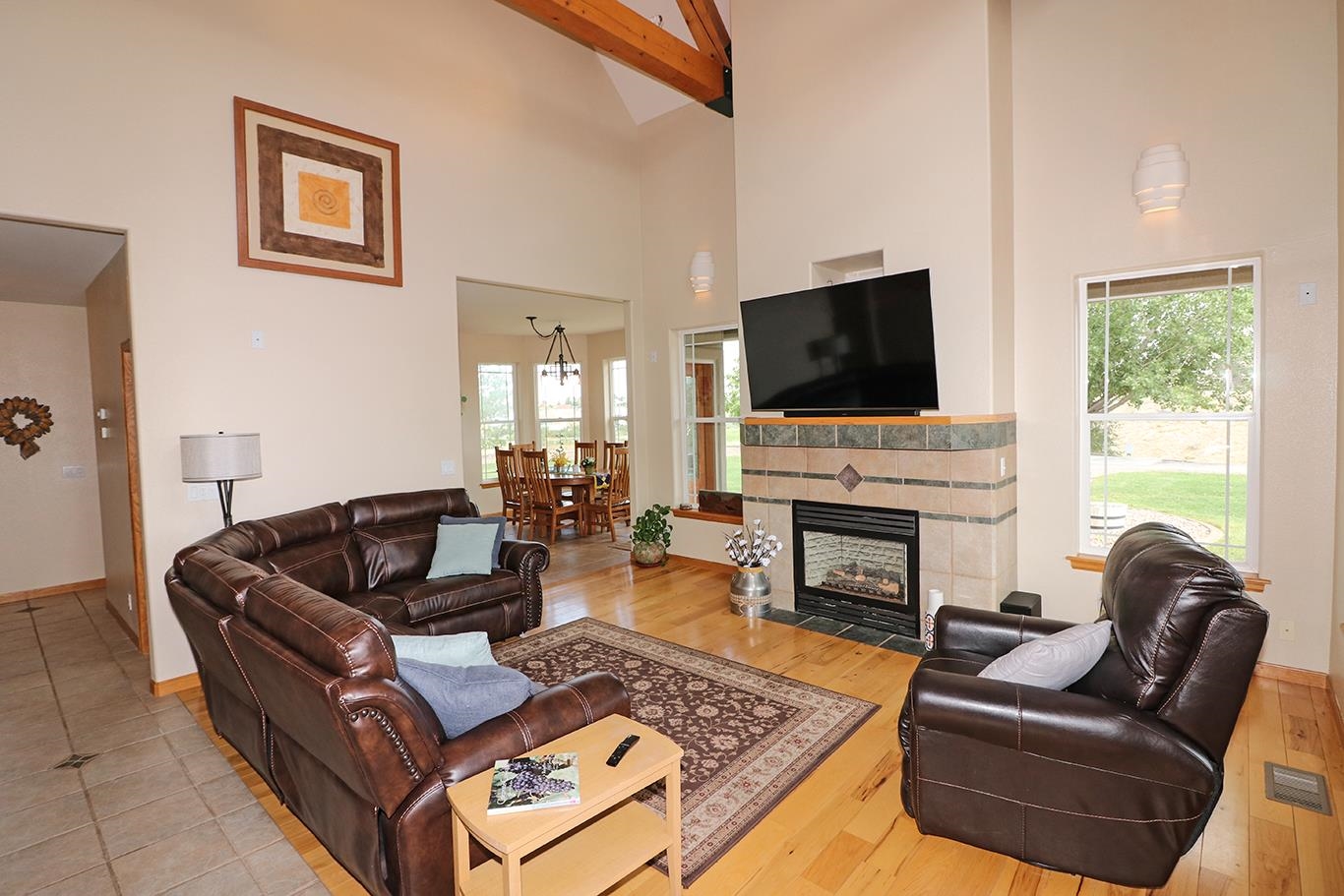 1198 23 Road Grand Junction, CO 81505 - Photo 5 of 32 a living room with furniture a fireplace and a flat screen tv