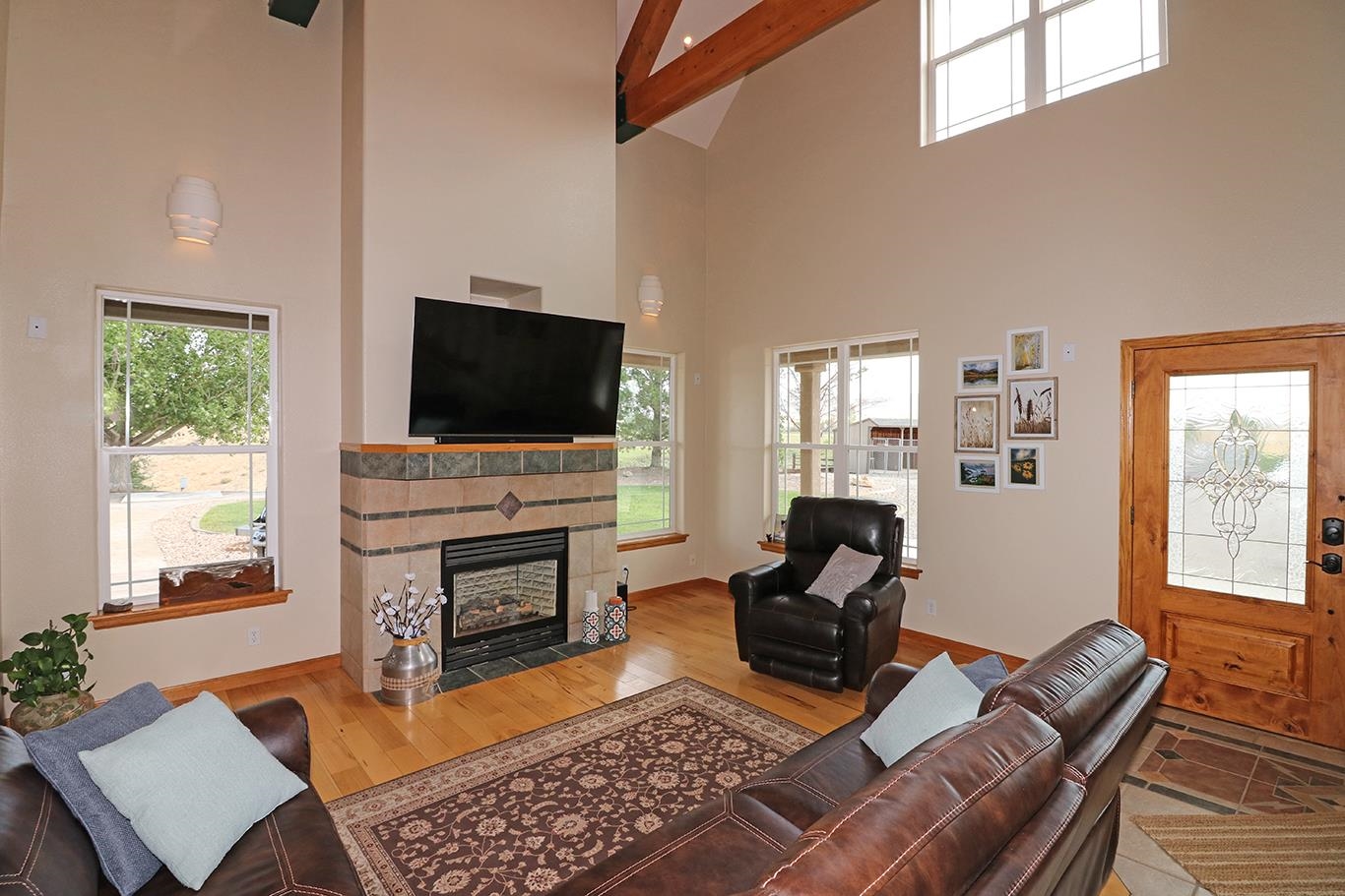 1198 23 Road Grand Junction, CO 81505 - Photo 8 of 32 a living room with furniture a flat screen tv and a fireplace