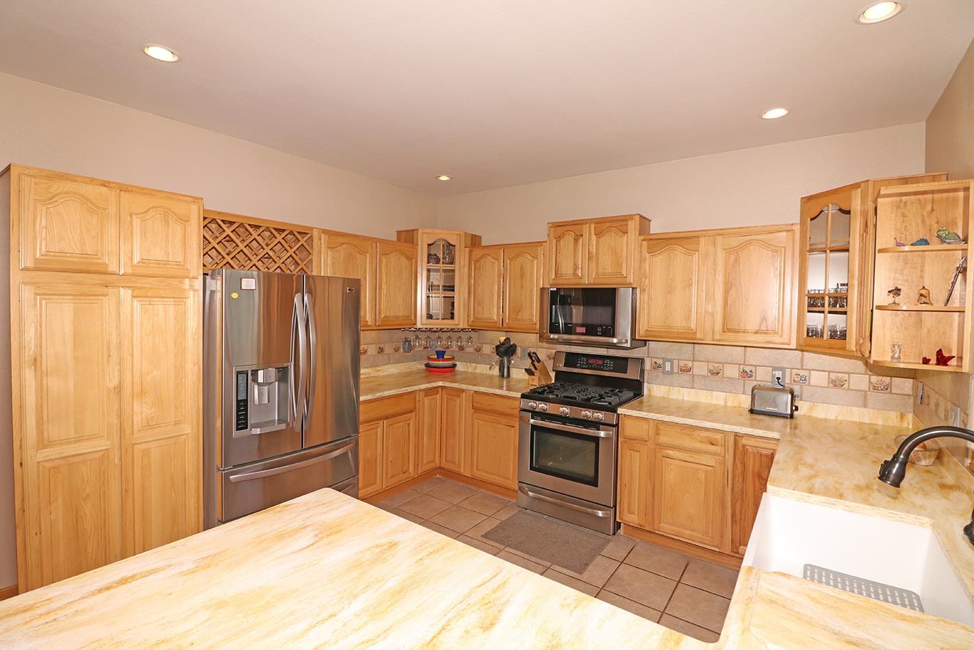 1198 23 Road Grand Junction, CO 81505 - Photo 10 of 32 a kitchen with stainless steel appliances granite countertop a refrigerator stove and sink