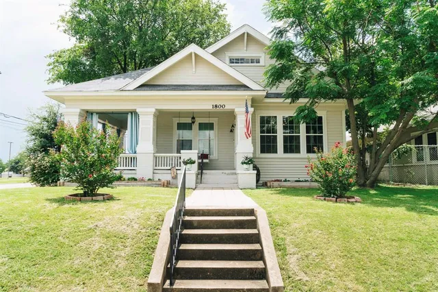 a front view of a house with swimming pool and porch