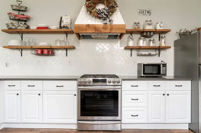 a stove top oven sitting inside of a kitchen