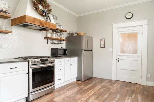 a kitchen with cabinets and steel stainless steel appliances