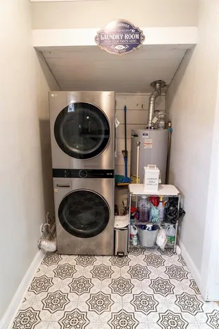 a living room with a couch and a stove with wooden floor