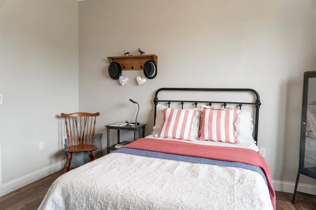 a bedroom with a bed and a chandelier