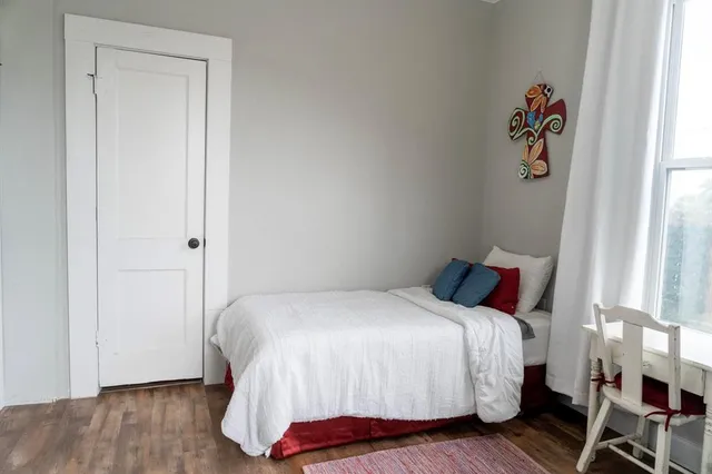 a bedroom with a bed and a window