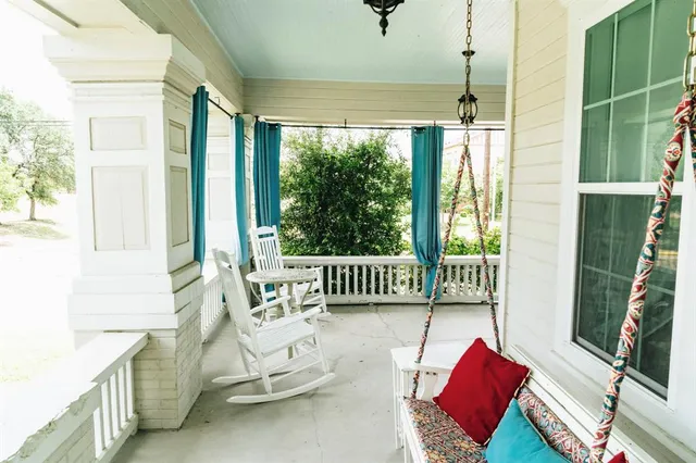 a bedroom with furniture and a large window