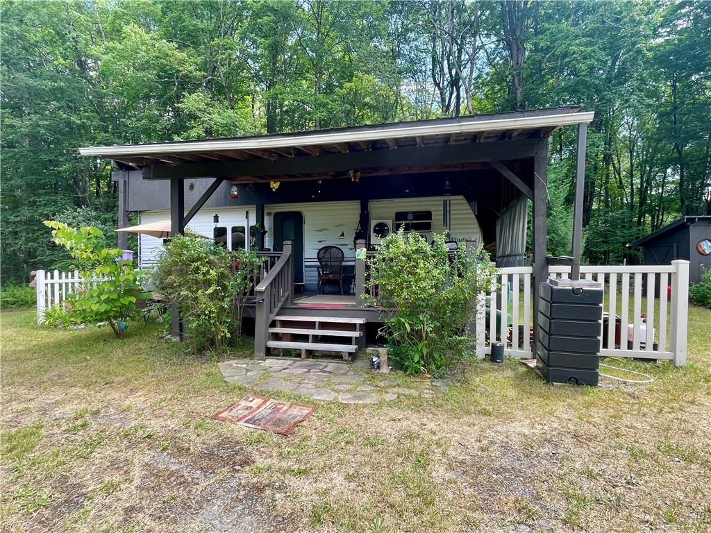 619 Town Line Road German, NY 13801 - Photo 1 of 38 Four Winds Dutchman RV & deck completely covered by metal roof awning.