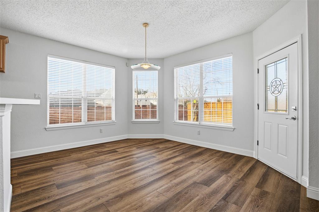 4425 Foxtail Lane Plano, TX 75024 - Photo 11 of 33 a view of an empty room with a window and wooden floor