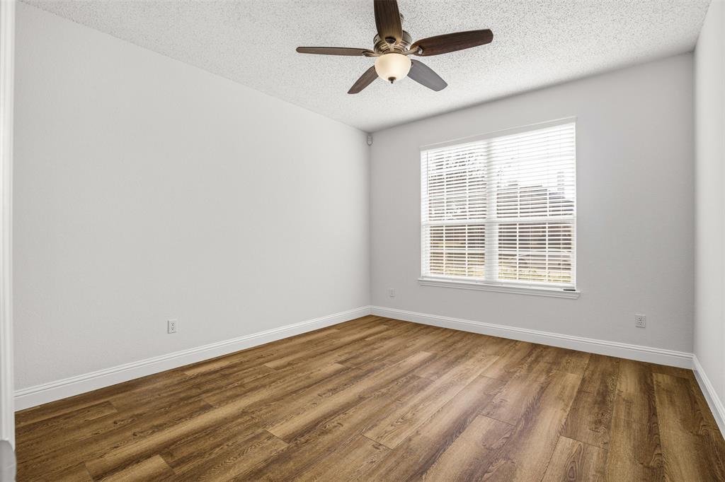 4425 Foxtail Lane Plano, TX 75024 - Photo 17 of 33 a view of an empty room with wooden floor and a window