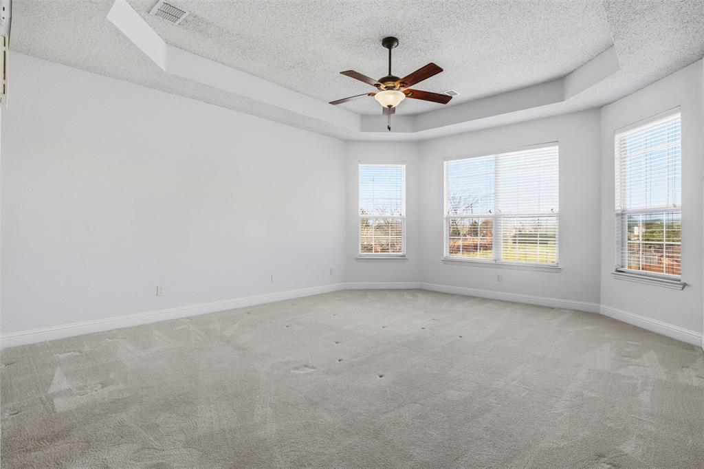4425 Foxtail Lane Plano, TX 75024 - Photo 18 of 33 an empty room with windows and fan
