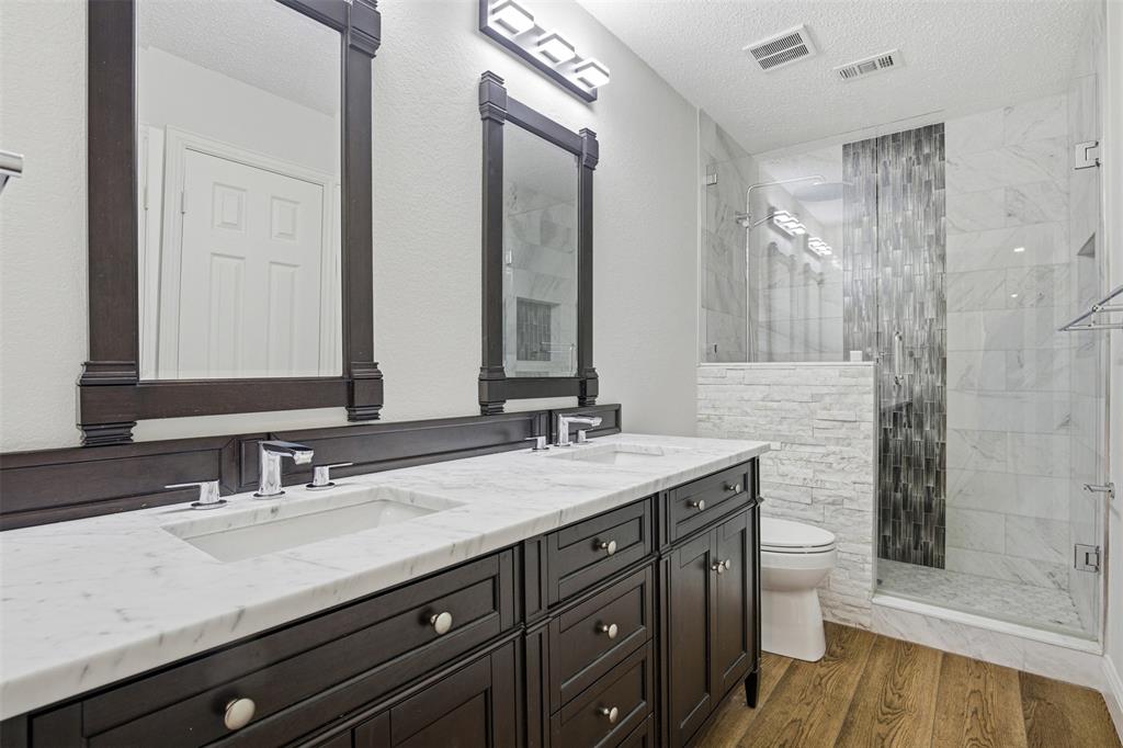 4425 Foxtail Lane Plano, TX 75024 - Photo 24 of 33 a bathroom with a granite countertop sink and a mirror