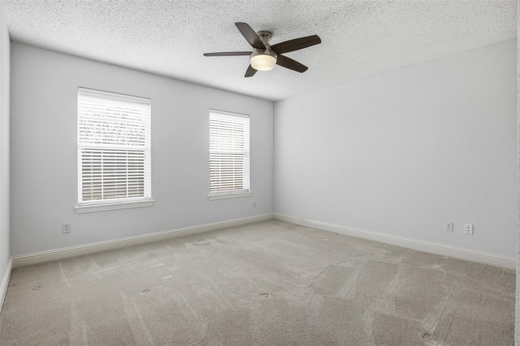 4425 Foxtail Lane Plano, TX 75024 - Photo 26 of 33 an empty room with a window and a ceiling fan