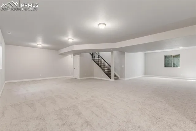 a view of an empty room with stairs