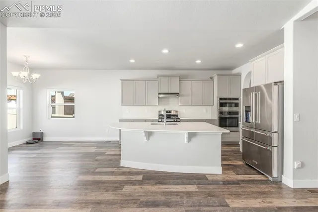 a kitchen with a refrigerator and a sink