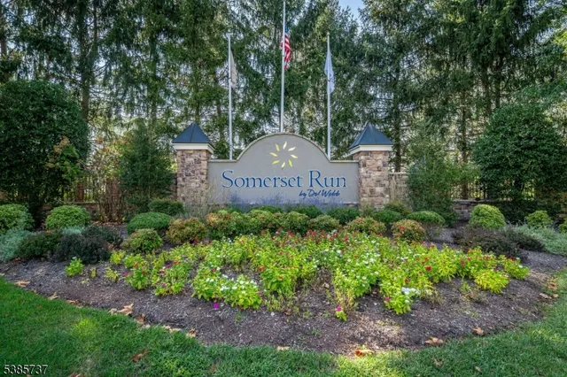 a sign of golf club on a stone wall