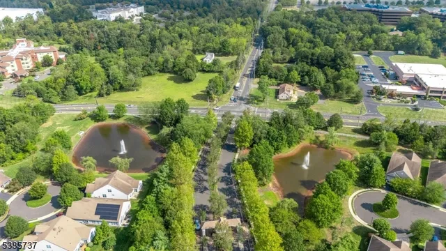 an aerial view of residential house with outdoor space and trees all around