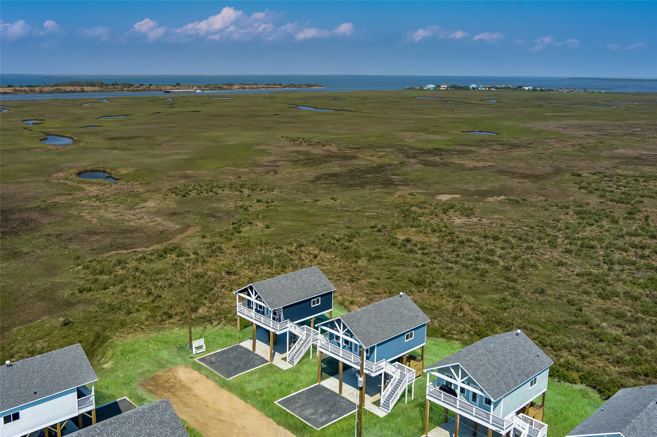 1084 Johnson Road Port Bolivar, TX 77650 - Photo 30 of 39 a view of a lake with a table under an umbrella