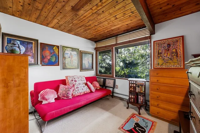 a living room with furniture a rug and a large window
