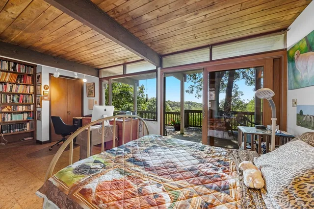 a bed room with a bed and glass windows