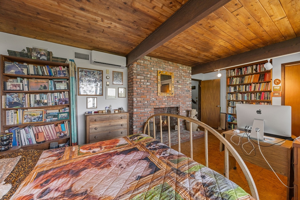 25 Resolution Road Truro, MA 02666 - Photo 21 of 42 a bedroom with furniture and a book shelf