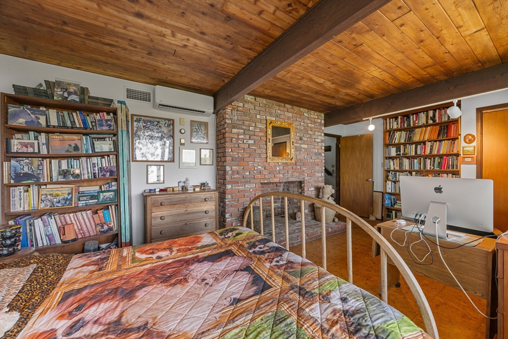 25 Resolution Road Truro, MA 02666 - Photo 22 of 42 a bedroom with furniture and a book shelf