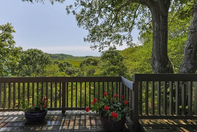 a view of a balcony with wooden floor