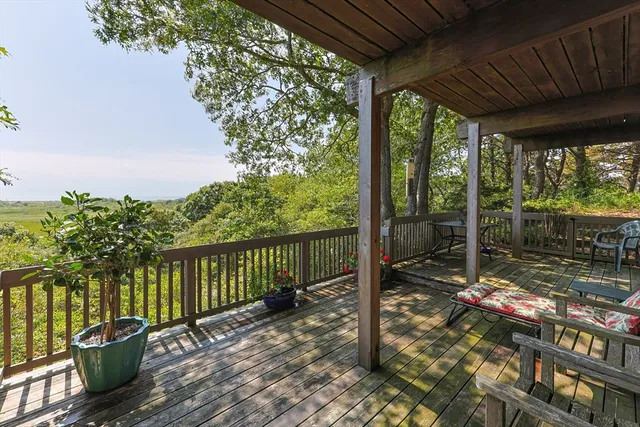 a view of a balcony with chair and wooden floor