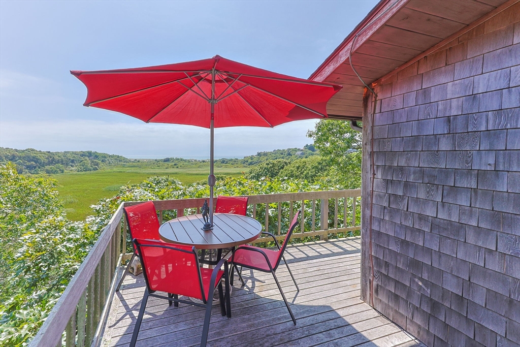 25 Resolution Road Truro, MA 02666 - Photo 31 of 42 a view of a outdoor sitting area with furniture and umbrella