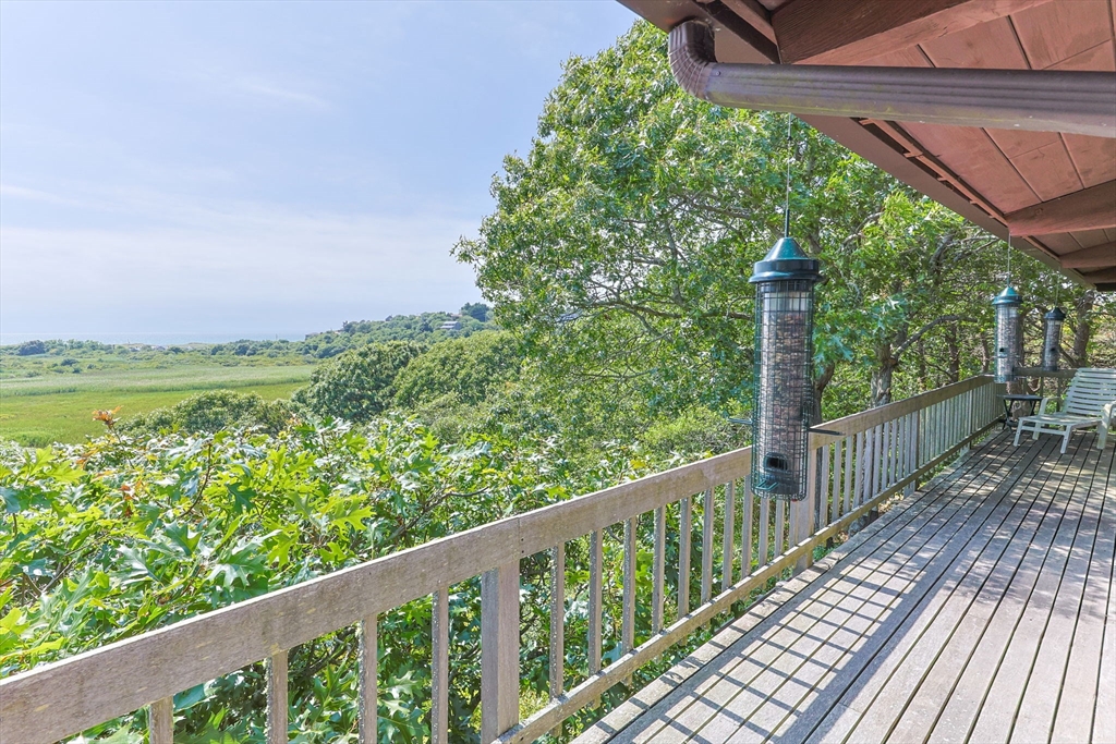25 Resolution Road Truro, MA 02666 - Photo 32 of 42 a view of a wooden deck next to a yard