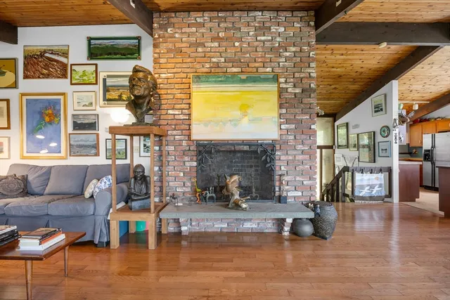 a view of a living room and kitchen with furniture