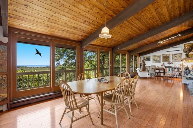 a dining room with furniture wooden floor and a rug