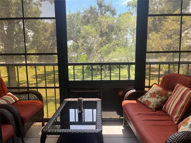 a living room with furniture tv and a window