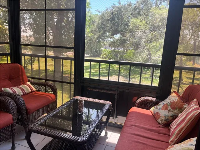 a living room with furniture and a floor to ceiling window