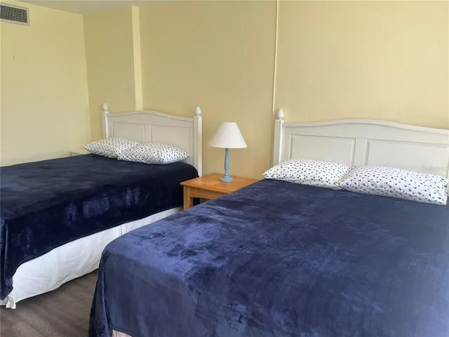 a bedroom with a bed and a lamp