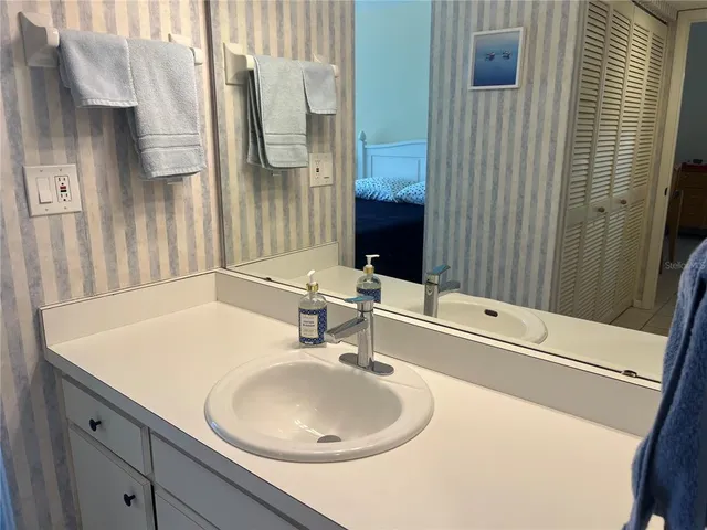 a bathroom with a sink and a mirror