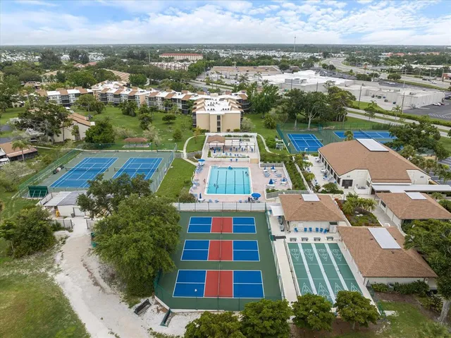 an aerial view of residential houses with outdoor space and swimming pool