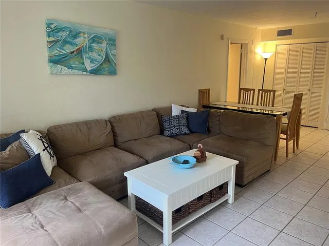 a living room with furniture and a night stand