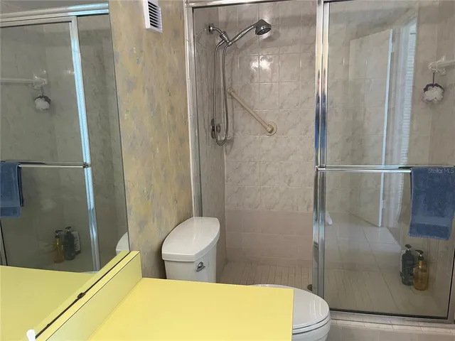a bathroom with a toilet and shower