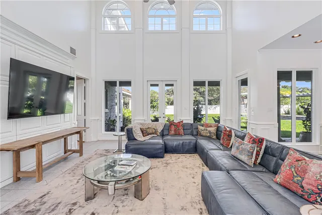 a living room with fireplace furniture and a potted plant