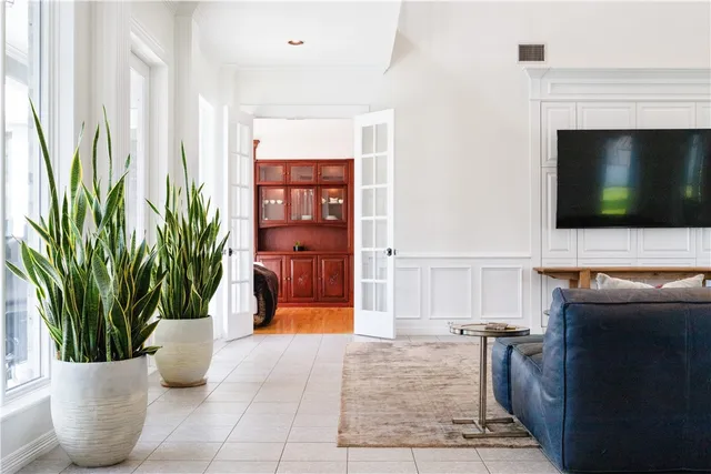 a dining room with furniture a large window and wooden floor