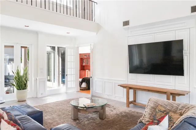 a large white kitchen with a sink a refrigerator and a stove top oven